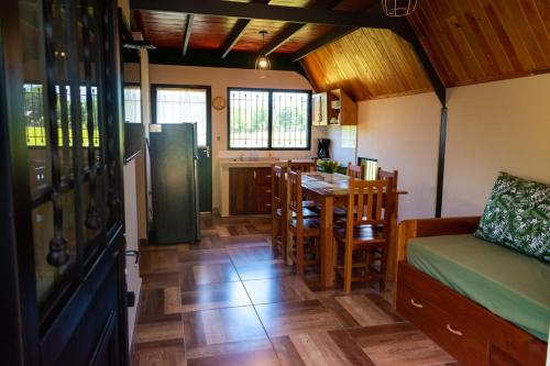 a living room with a kitchen and a dining room at Campo Verde Bungalows in Capitán Miranda