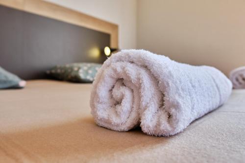 a towel that is sitting on a bed at chateau d'escart in Arvillard