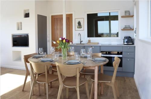 a dining room with a table and chairs in a kitchen at Eco-lodge with hottub + 2 wc in Elie