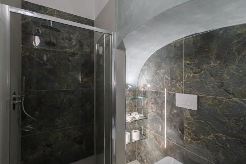 a shower with a glass door in a bathroom at Alessia Holiday House 90mq Salerno Centro in Salerno
