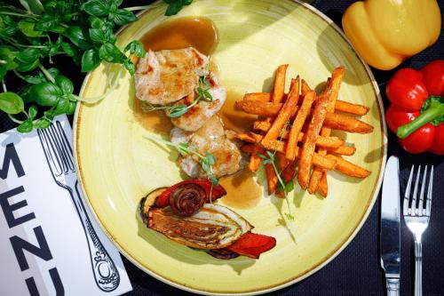 a plate of food with a sandwich and french fries at Hotel Kompleks Beskid z basenem i stokiem narciarskim - blisko Babiej Góry in Spytkowice