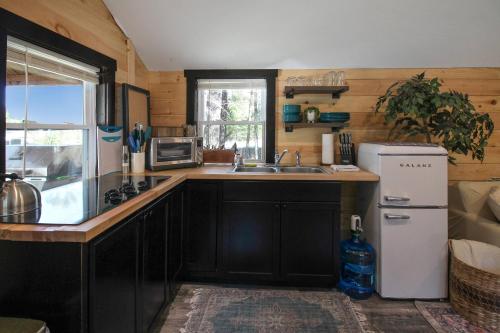 a kitchen with a sink and a refrigerator at Travelers Haven in Whitefield