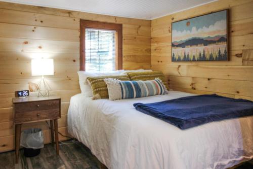 a bedroom with a bed in a log cabin at Travelers Haven in Whitefield