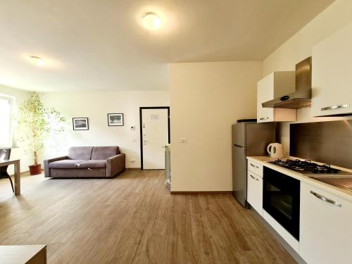 a kitchen and living room with a couch in a room at Santa Caterina in Levanto
