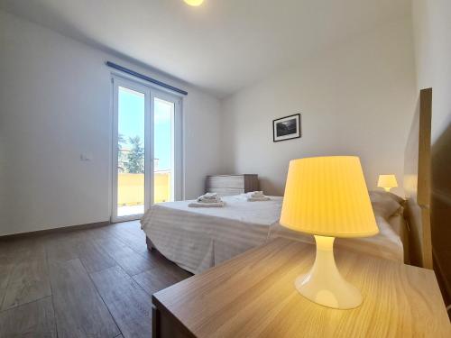 a bedroom with a bed and a lamp on a table at Santa Caterina in Levanto