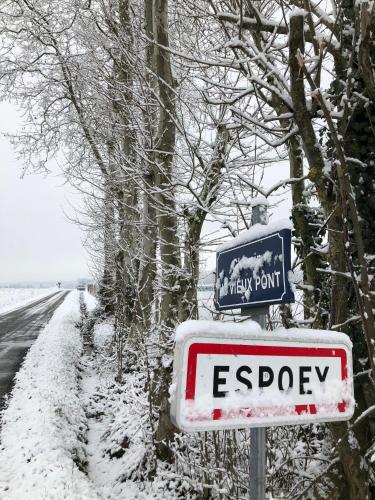 a street sign on the side of a snow covered road at Les Hortensias in Espoey