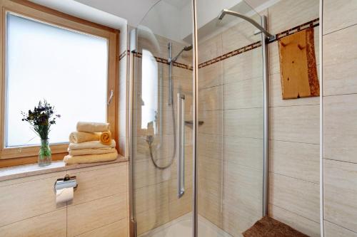 a bathroom with a shower with a glass door at Oberhof Apt Ilmenspitz in Larcher