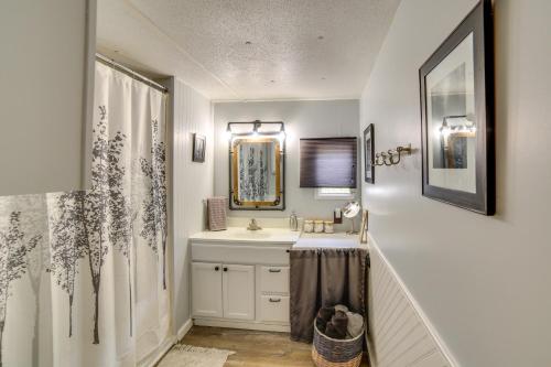 a bathroom with a sink and a mirror at Lakefront Wisconsin Home with Boat Dock and Fire Pit! 
