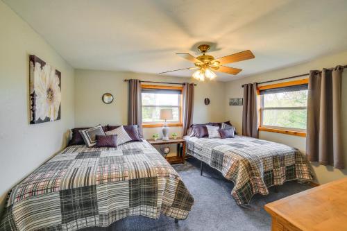 a bedroom with two beds and a ceiling fan at Lakefront Wisconsin Home with Boat Dock and Fire Pit! 