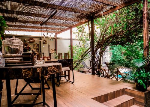 a patio with a table and chairs and a bird cage at Casa Perpetua Hotel D Charm in Manaus