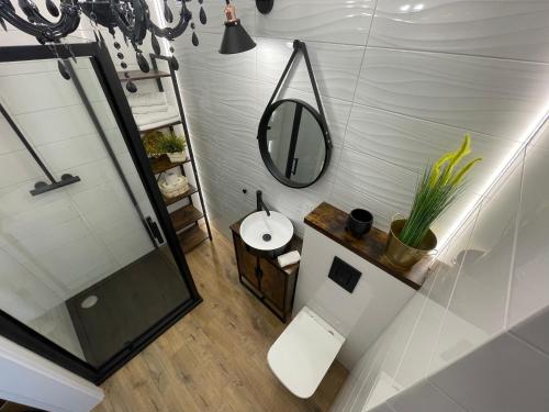 a bathroom with a sink and a mirror at Apartament 32 NOWA WIEJSKA Olecko Mazury Garbate in Olecko