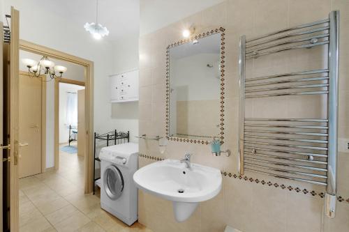 a bathroom with a sink and a washing machine at Villa Montali in Santa Margherita di Pula