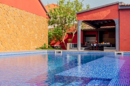 a swimming pool in front of a house at Aroeira Pool House by Lisbon-Coast vacation in Charneca