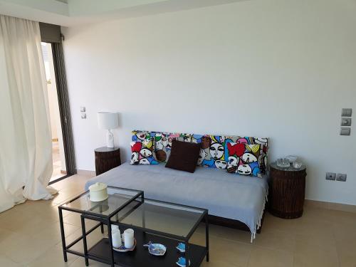 a bedroom with a bed with pillows and a table at RVG Rania House with pool in Porto Heli