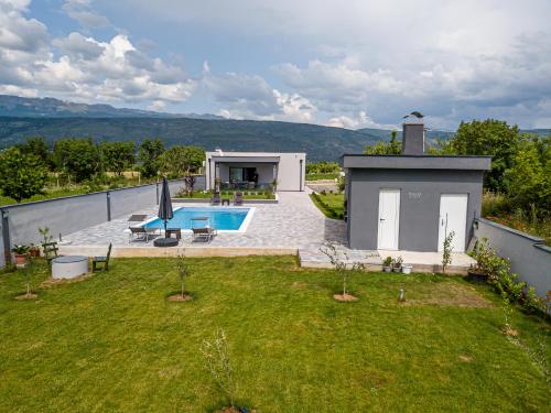a backyard with a swimming pool and a house at Villa Vukas in Mostar