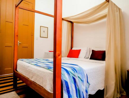 a bedroom with a bed with a canopy at Casa Perpetua Hotel D Charm in Manaus