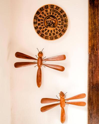 two bugs on a wall with a clock on it at Casa Perpetua Hotel D Charm in Manaus
