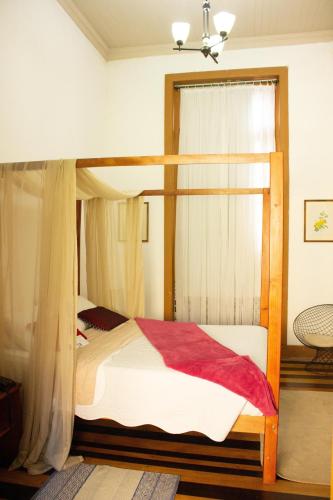 a bedroom with a bunk bed with a canopy at Casa Perpetua Hotel D Charm in Manaus