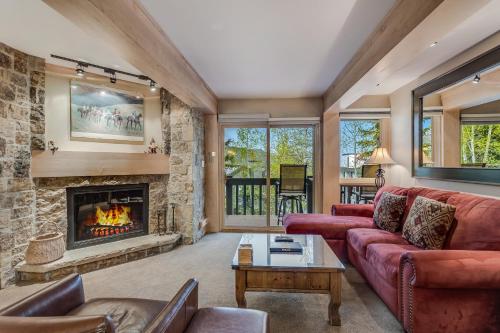 a living room with a couch and a fireplace at Interlude Condominiums 2-Bedroom Unit 202 in Snowmass Village