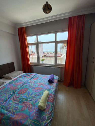 a bedroom with a bed and a large window at Old town kagitci apart in Istanbul