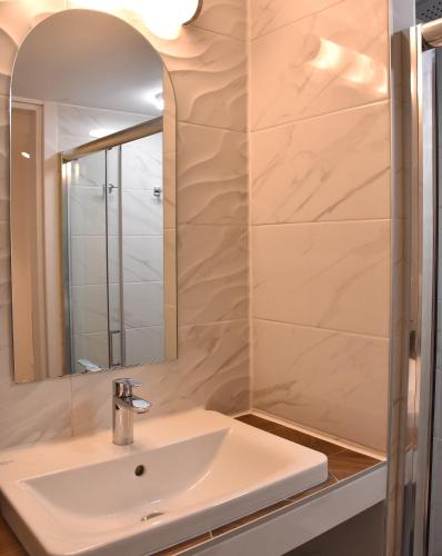 a bathroom with a sink and a mirror at The art studio in Samothraki