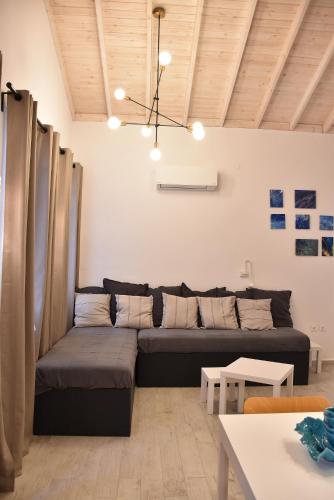 a living room with a couch and a table at The art studio in Samothraki