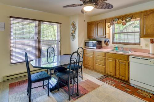 a kitchen with a table and chairs and a sink at Fire Pit, Kayak and Gas Grill Pocono Lake Home! in Pocono Lake