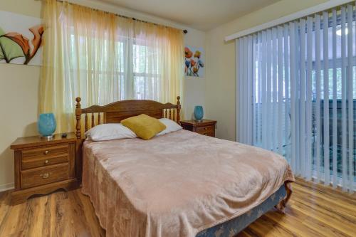 a bedroom with a bed and a large window at Fire Pit, Kayak and Gas Grill Pocono Lake Home! in Pocono Lake