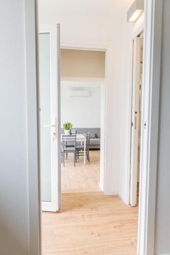 a hallway leading to a dining room with a table at Residence Il Poggio in Dorio