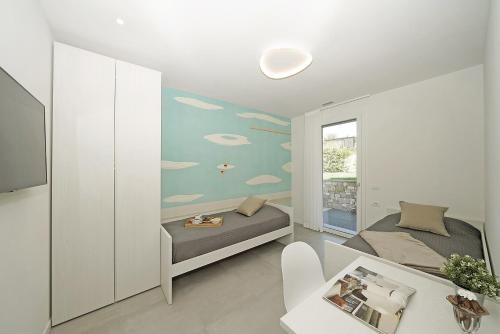 a bedroom with a bed and a wall with clouds at Villa Ester by Wonderful Italy in Moniga