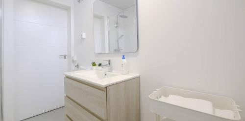 a white bathroom with a sink and a mirror at My City Home - Acogedor estudio en Ciudad Lineal in Madrid