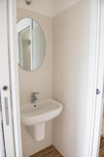a bathroom with a sink and a mirror at Residence Il Poggio in Dorio
