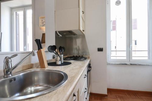 a kitchen with a sink and a stove at RomeCentro 5minuti dalla stazione in Rome