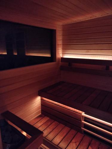 a sauna with wooden floors and benches in a room at Jucus Vendégház in Zebegény
