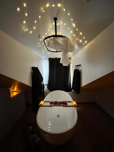a room with a ceiling with lights and a toilet at Le Nid d'Amour - Escapade Romantique in Dieppe