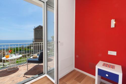 a room with a balcony with a view of the ocean at YourHome - Relais Loggia Li Galli in Massa Lubrense