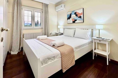 a bedroom with a large white bed and a window at Hippocrates house in Kos Town