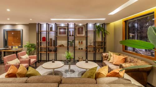 a living room with a couch and two tables at Rugendas Hotel Boutique by Time in Santiago
