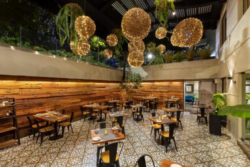 a restaurant with tables and chairs and lights at Rugendas Hotel Boutique by Time in Santiago