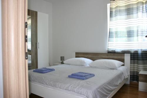 a bedroom with a bed with two towels on it at Apartments Antea in Trogir
