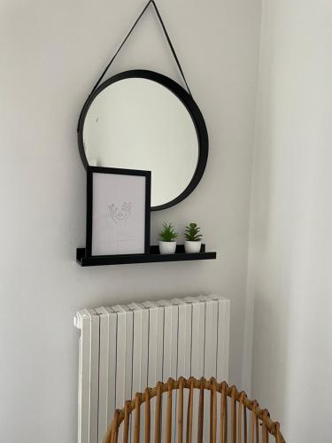 a mirror on a wall above a radiator at La casa di Michelle in Foggia