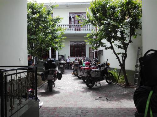 a row of motorcycles parked in front of a building at Green House Hostel in Dushanbe