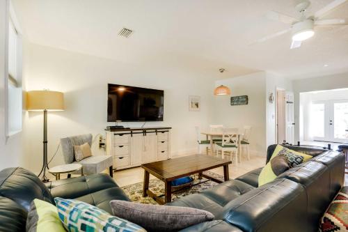 a living room with a couch and a table at St Augustine Cottage with Fire Pit - Walk to Pier! in Saint Augustine Beach