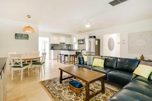 a living room with a couch and a table at St Augustine Cottage with Fire Pit - Walk to Pier! in Saint Augustine Beach