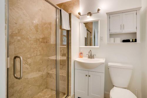 a bathroom with a shower and a toilet and a sink at St Augustine Cottage with Fire Pit - Walk to Pier! in Saint Augustine Beach