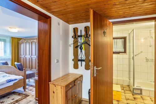 a room with a door open to a bathroom with skis on the wall at Müller in Bad Herrenalb