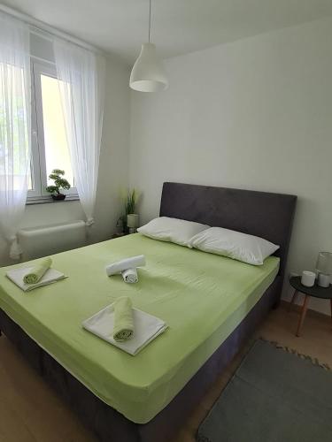 a bedroom with a bed with two towels on it at Apartment Alea in Senj