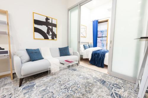 a living room with a couch and a bed at 317-4A NEW Modern 1BR W&D Walk to Central Park in New York