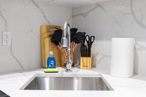 a kitchen sink with a faucet and utensils at 317-4A NEW Modern 1BR W&D Walk to Central Park in New York