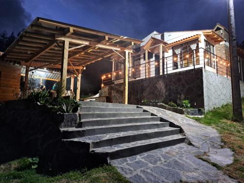 a house with a set of stairs in front of it at Cabaña Campestre Montreal in Paipa